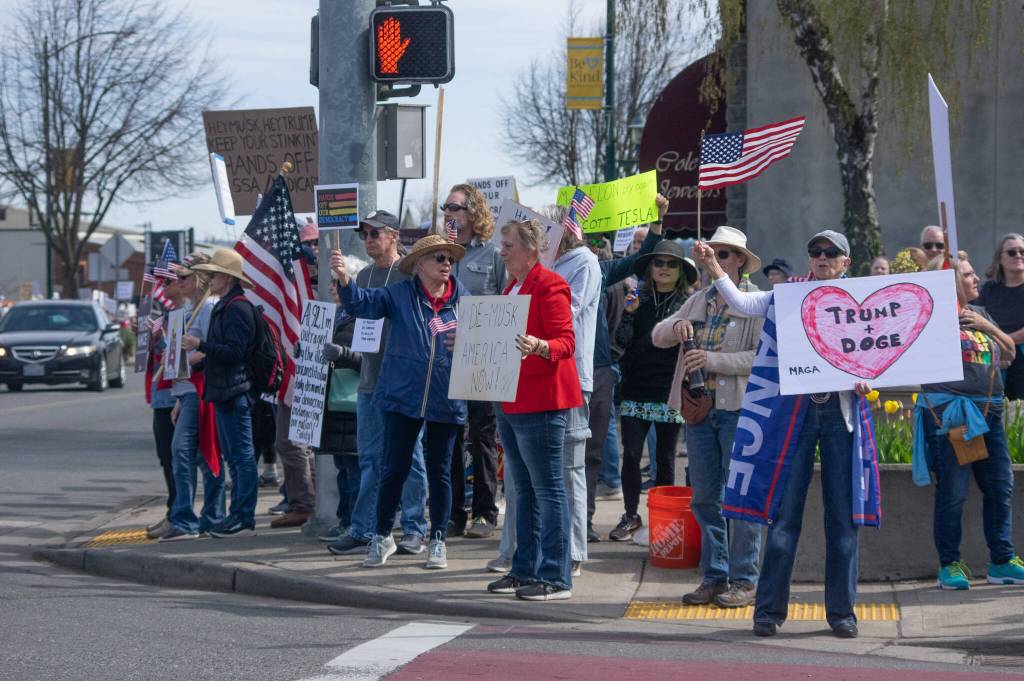 Sequim Gazette photo by Emily Matthiessen/ According to a clicker count by volunteers with Sequim Indivisible, 1298 people turned out by 11:45 a.m., with nearly 1400 people counted by 2:00 p.m. during Sequims version of the Hands Off  protests held across the nation and in other countries on Saturday. The protest was peaceful and orderly, according to police, organizers and protesters and featured a range of protest signs.