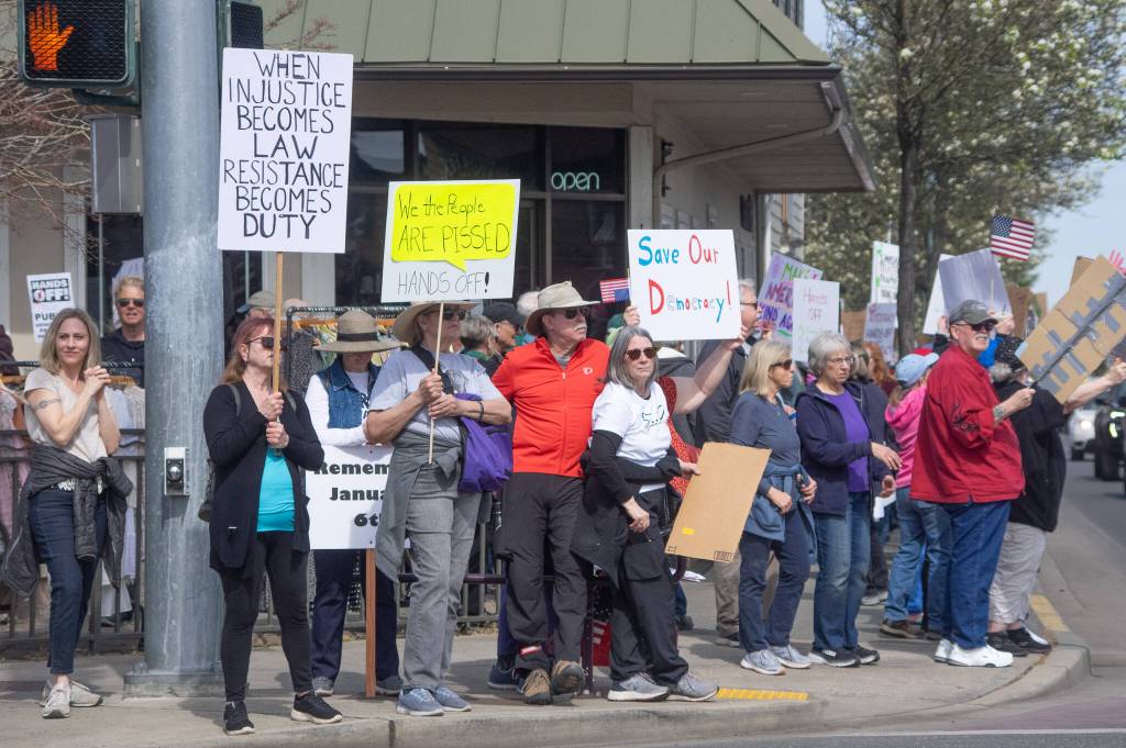 Sequim Gazette photo by Emily Matthiessen/ According to a clicker count by volunteers with Sequim Indivisible, 1298 people turned out by 11:45 a.m., with nearly 1400 people counted by 2:00 p.m. during Sequims version of the Hands Off  protests held across the nation and in other countries on Saturday. The protest was peaceful and orderly, according to police, organizers and protesters and featured a range of protest signs.