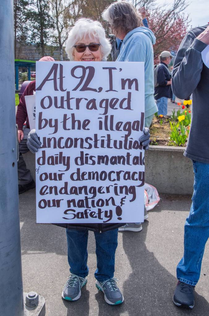 Sequim Gazette photo by Emily Matthiessen/ According to a clicker count by volunteers with Sequim Indivisible, 1298 people turned out by 11:45 a.m., with nearly 1400 people counted by 2:00 p.m. during Sequims version of the Hands Off  protests held across the nation and in other countries on Saturday. The protest was peaceful and orderly, according to police, organizers and protesters and featured a range of protest signs.