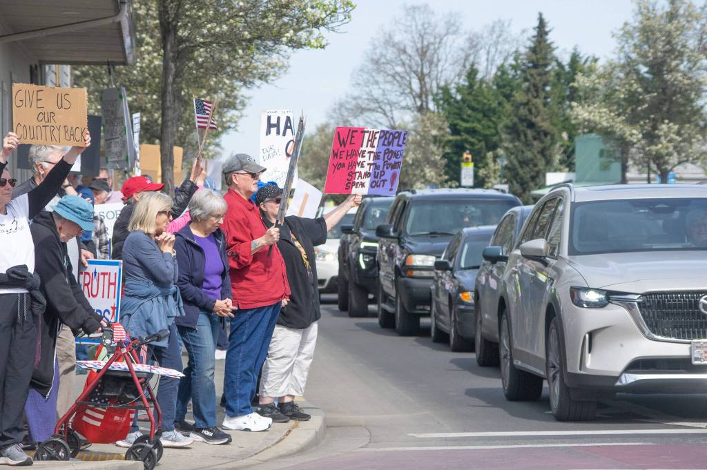 Sequim Gazette photo by Emily Matthiessen/ According to a clicker count by volunteers with Sequim Indivisible, 1298 people turned out by 11:45 a.m., with nearly 1400 people counted by 2:00 p.m. during Sequims version of the Hands Off  protests held across the nation and in other countries on Saturday. The protest was peaceful and orderly, according to police, organizers and protesters and featured a range of protest signs.