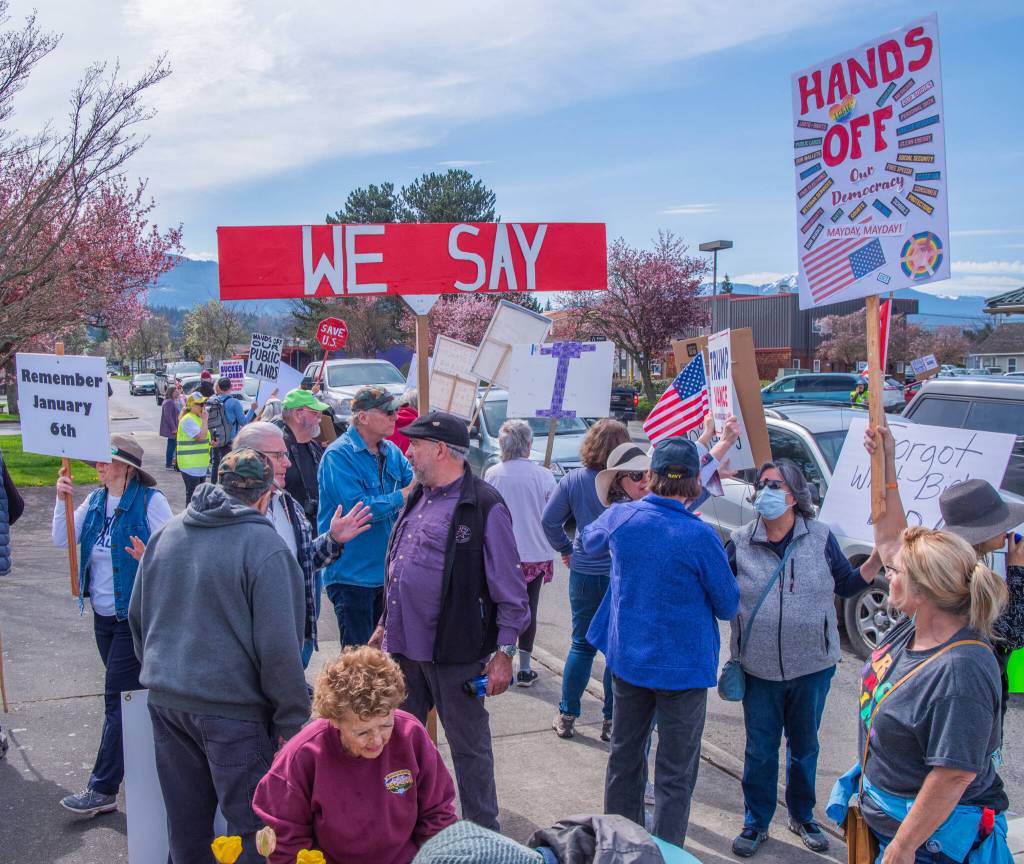Sequim Gazette photo by Emily Matthiessen/ According to a clicker count by volunteers with Sequim Indivisible, 1298 people turned out by 11:45 a.m., with nearly 1400 people counted by 2:00 p.m. during Sequims version of the Hands Off  protests held across the nation and in other countries on Saturday. The protest was peaceful and orderly, according to police, organizers and protesters and featured a range of protest signs.