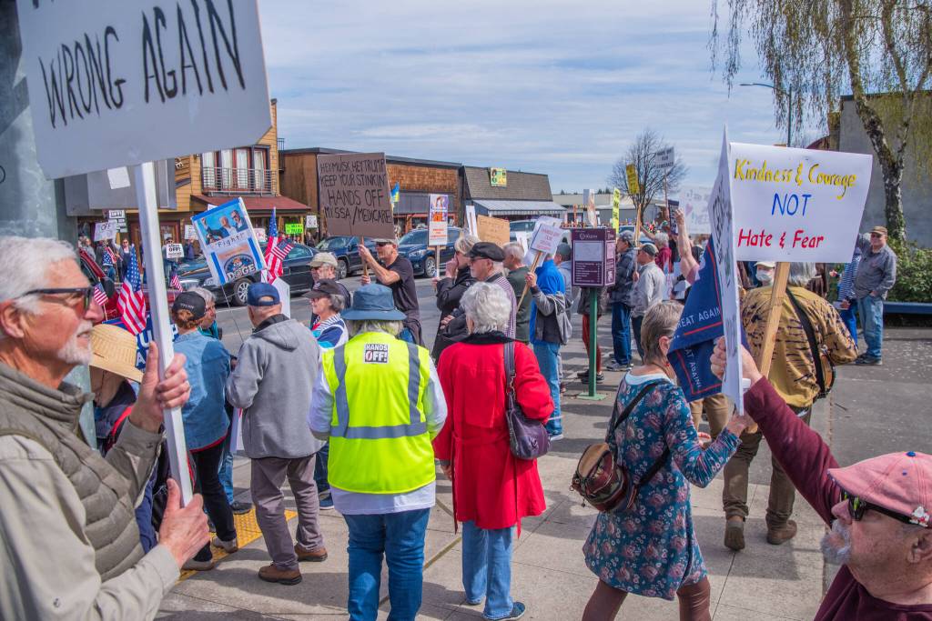 Sequim Gazette photo by Emily Matthiessen/ According to a clicker count by volunteers with Sequim Indivisible, 1298 people turned out by 11:45 a.m., with nearly 1400 people counted by 2:00 p.m. during Sequims version of the Hands Off  protests held across the nation and in other countries on Saturday. The protest was peaceful and orderly, according to police, organizers and protesters and featured a range of protest signs.