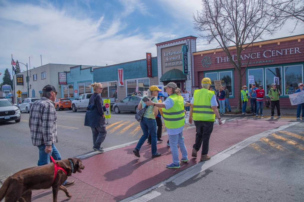 Sequim Gazette photo by Emily Matthiessen/ According to a clicker count by volunteers with Sequim Indivisible, 1298 people turned out by 11:45 a.m., with nearly 1400 people counted by 2:00 p.m. during Sequim's version of the "Hands Off " protests held across the nation and in other countries on Saturday. The protest was peaceful and orderly, according to police, organizers and protesters and featured a range of protest signs.