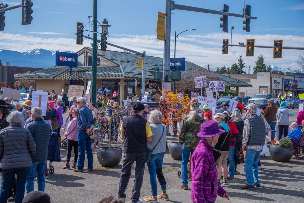 Sequim Gazette photo by Emily Matthiessen/ According to a clicker count by volunteers with Sequim Indivisible, 1298 people turned out by 11:45 a.m., with nearly 1400 people counted by 2:00 p.m. during Sequim's version of the "Hands Off " protests held across the nation and in other countries on Saturday. The protest was peaceful and orderly, according to police, organizers and protesters and featured a range of protest signs.