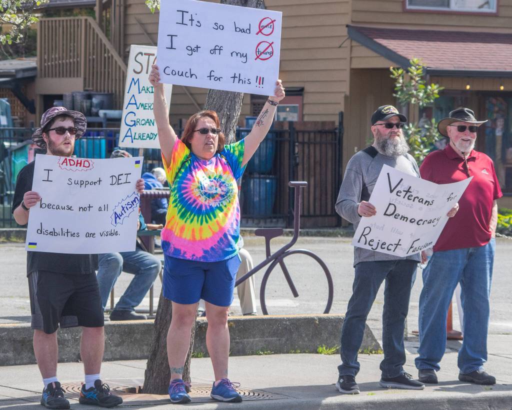 Sequim Gazette photo by Emily Matthiessen/ According to a clicker count by volunteers with Sequim Indivisible, 1298 people turned out by 11:45 a.m., with nearly 1400 people counted by 2:00 p.m. during Sequim's version of the "Hands Off " protests held across the nation and in other countries on Saturday. The protest was peaceful and orderly, according to police, organizers and protesters and featured a range of protest signs.