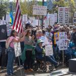 Sequim Gazette photo by Emily Matthiessen/ According to a clicker count by volunteers with Sequim Indivisible, 1298 people turned out by 11:45 a.m., with nearly 1400 people counted by 2:00 p.m. during Sequim's version of the "Hands Off " protests held across the nation and in other countries on Saturday. The protest was peaceful and orderly, according to police, organizers and protesters and featured a range of protest signs.