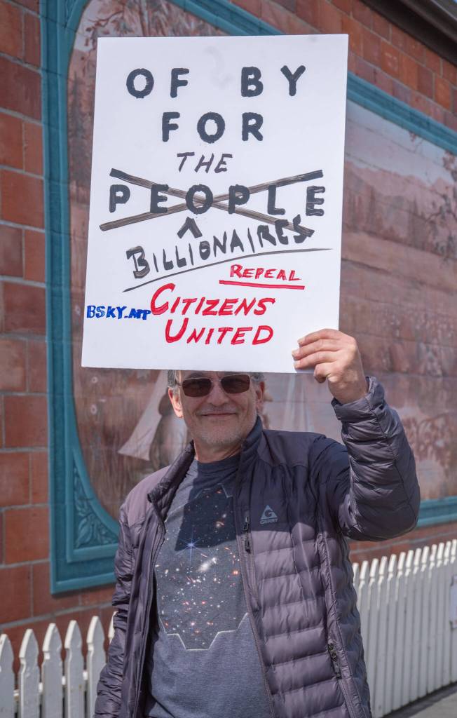 Sequim Gazette photo by Emily Matthiessen/ According to a clicker count by volunteers with Sequim Indivisible, 1298 people turned out by 11:45 a.m., with nearly 1400 people counted by 2:00 p.m. during Sequim's version of the "Hands Off " protests held across the nation and in other countries on Saturday. The protest was peaceful and orderly, according to police, organizers and protesters and featured a range of protest signs.
