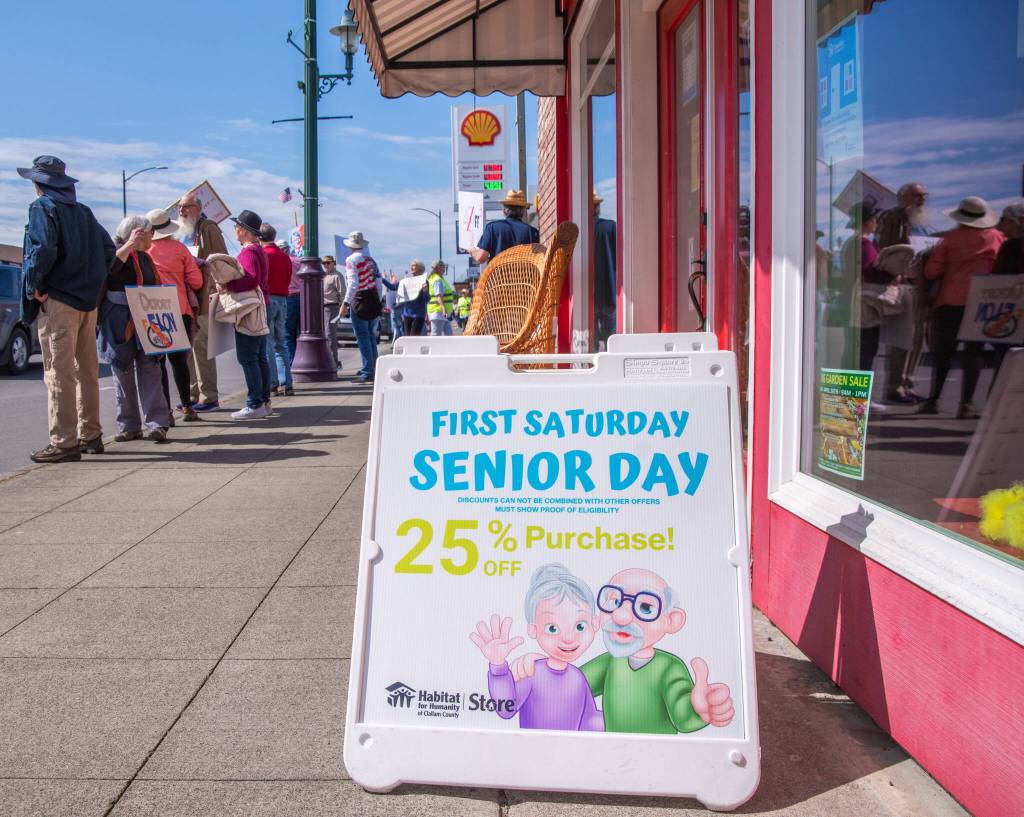 Sequim Gazette photo by Emily Matthiessen/ According to a clicker count by volunteers with Sequim Indivisible, 1298 people turned out by 11:45 a.m., with nearly 1400 people counted by 2:00 p.m. during Sequim's version of the "Hands Off " protests held across the nation and in other countries on Saturday. The protest was peaceful and orderly, according to police, organizers and protesters and featured a range of protest signs.