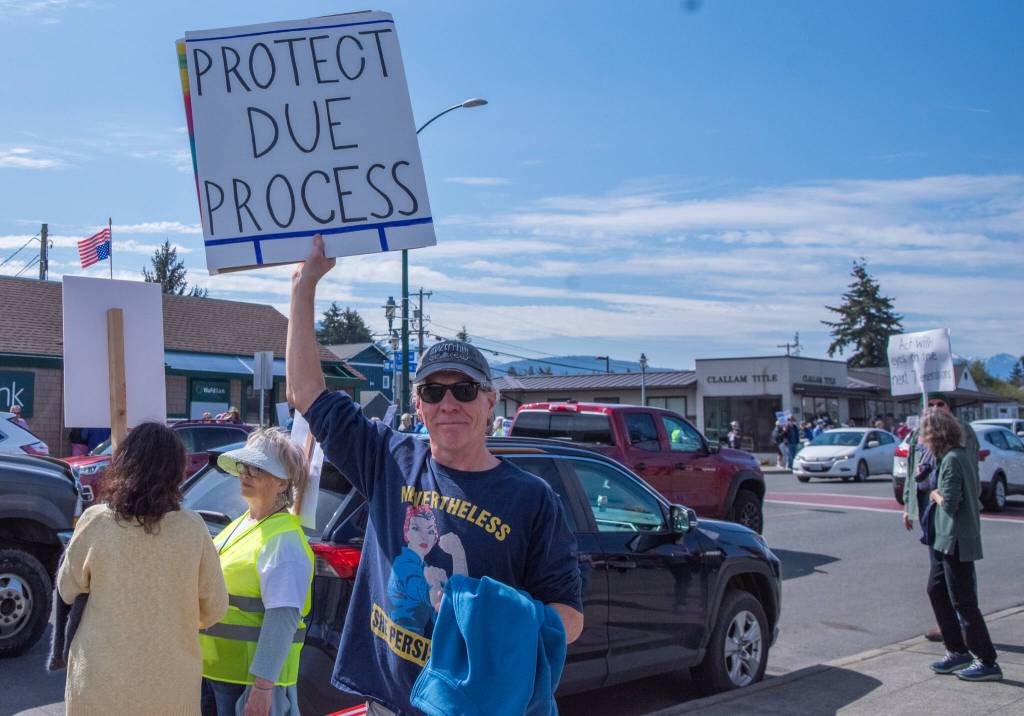 Sequim Gazette photo by Emily Matthiessen/ According to a clicker count by volunteers with Sequim Indivisible, 1298 people turned out by 11:45 a.m., with nearly 1400 people counted by 2:00 p.m. during Sequim's version of the "Hands Off " protests held across the nation and in other countries on Saturday. The protest was peaceful and orderly, according to police, organizers and protesters and featured a range of protest signs.