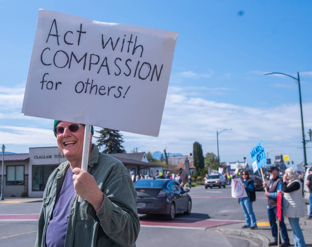 Sequim Gazette photo by Emily Matthiessen/ According to a clicker count by volunteers with Sequim Indivisible, 1298 people turned out by 11:45 a.m., with nearly 1400 people counted by 2:00 p.m. during Sequim's version of the "Hands Off " protests held across the nation and in other countries on Saturday. The protest was peaceful and orderly, according to police, organizers and protesters and featured a range of protest signs.