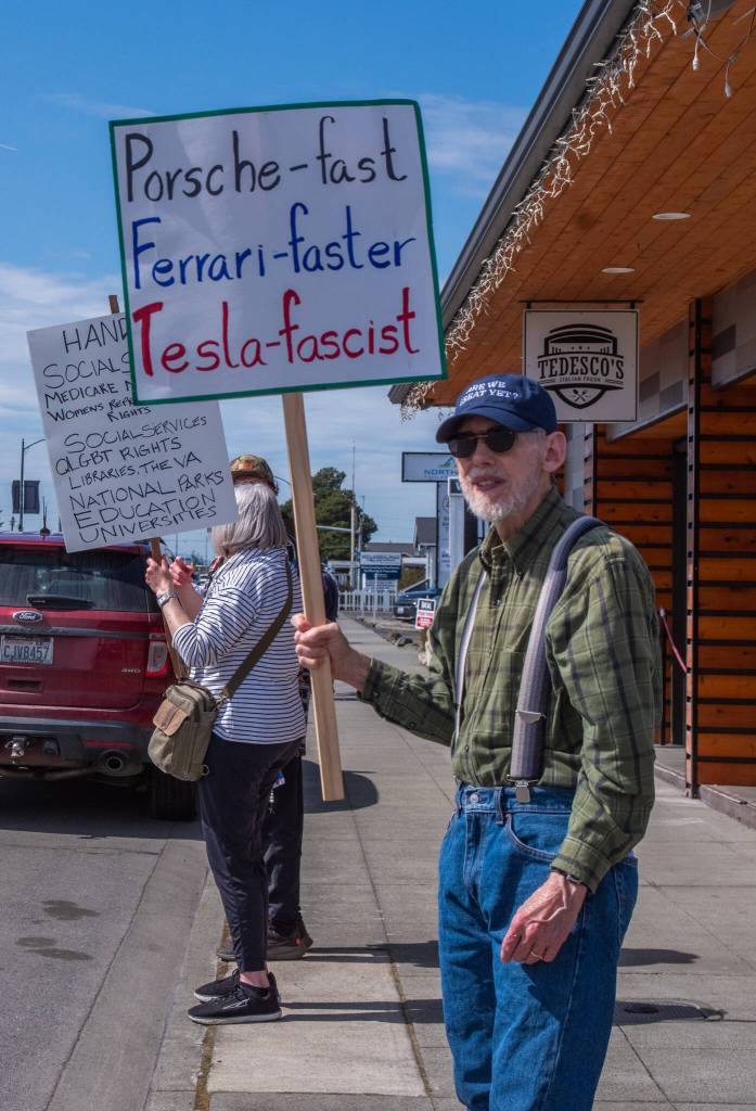 Sequim Gazette photo by Emily Matthiessen/ According to a clicker count by volunteers with Sequim Indivisible, 1298 people turned out by 11:45 a.m., with nearly 1400 people counted by 2:00 p.m. during Sequim's version of the "Hands Off " protests held across the nation and in other countries on Saturday. The protest was peaceful and orderly, according to police, organizers and protesters and featured a range of protest signs.