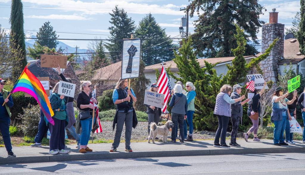 Sequim Gazette photo by Emily Matthiessen/ According to a clicker count by volunteers with Sequim Indivisible, 1298 people turned out by 11:45 a.m., with nearly 1400 people counted by 2:00 p.m. during Sequim's version of the "Hands Off " protests held across the nation and in other countries on Saturday. The protest was peaceful and orderly, according to police, organizers and protesters and featured a range of protest signs.