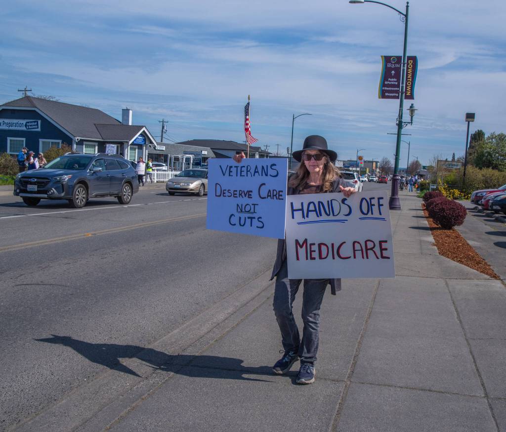 Sequim Gazette photo by Emily Matthiessen/ According to a clicker count by volunteers with Sequim Indivisible, 1298 people turned out by 11:45 a.m., with nearly 1400 people counted by 2:00 p.m. during Sequim's version of the "Hands Off " protests held across the nation and in other countries on Saturday. The protest was peaceful and orderly, according to police, organizers and protesters and featured a range of protest signs.