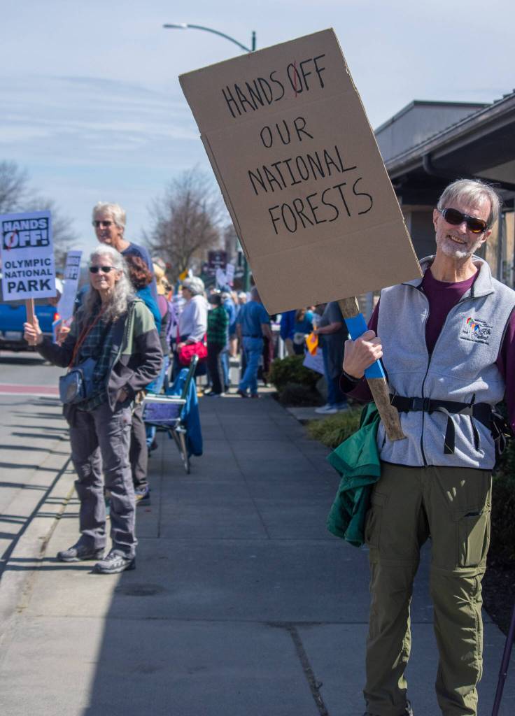 Sequim Gazette photo by Emily Matthiessen/ According to a clicker count by volunteers with Sequim Indivisible, 1298 people turned out by 11:45 a.m., with nearly 1400 people counted by 2:00 p.m. during Sequim's version of the "Hands Off " protests held across the nation and in other countries on Saturday. The protest was peaceful and orderly, according to police, organizers and protesters and featured a range of protest signs.