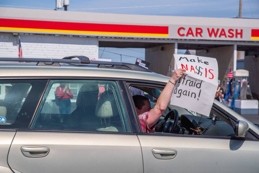 Sequim Gazette photo by Emily Matthiessen/ According to a clicker count by volunteers with Sequim Indivisible, 1298 people turned out by 11:45 a.m., with nearly 1400 people counted by 2:00 p.m. during Sequim's version of the "Hands Off " protests held across the nation and in other countries on Saturday. The protest was peaceful and orderly, according to police, organizers and protesters and featured a range of protest signs.
