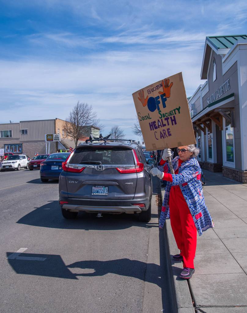 Sequim Gazette photo by Emily Matthiessen/ According to a clicker count by volunteers with Sequim Indivisible, 1298 people turned out by 11:45 a.m., with nearly 1400 people counted by 2:00 p.m. during Sequim's version of the "Hands Off " protests held across the nation and in other countries on Saturday. The protest was peaceful and orderly, according to police, organizers and protesters and featured a range of protest signs.