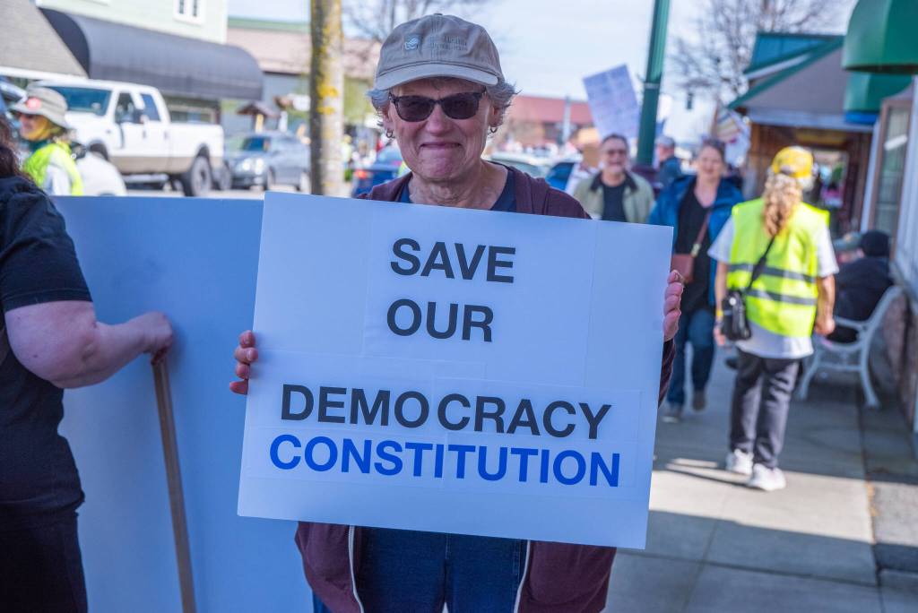 Sequim Gazette photo by Emily Matthiessen/ According to a clicker count by volunteers with Sequim Indivisible, 1298 people turned out by 11:45 a.m., with nearly 1400 people counted by 2:00 p.m. during Sequim's version of the "Hands Off " protests held across the nation and in other countries on Saturday. The protest was peaceful and orderly, according to police, organizers and protesters and featured a range of protest signs.