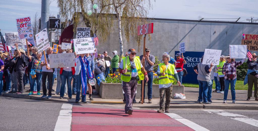 Sequim Gazette photo by Emily Matthiessen/ According to a clicker count by volunteers with Sequim Indivisible, 1298 people turned out by 11:45 a.m., with nearly 1400 people counted by 2:00 p.m. during Sequim's version of the "Hands Off " protests held across the nation and in other countries on Saturday. The protest was peaceful and orderly, according to police, organizers and protesters and featured a range of protest signs.
