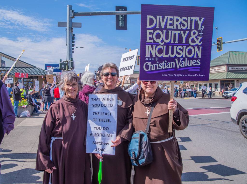 Sequim Gazette photo by Emily Matthiessen/ According to a clicker count by volunteers with Sequim Indivisible, 1298 people turned out by 11:45 a.m., with nearly 1400 people counted by 2:00 p.m. during Sequim's version of the "Hands Off " protests held across the nation and in other countries on Saturday. The protest was peaceful and orderly, according to police, organizers and protesters and featured a range of protest signs.