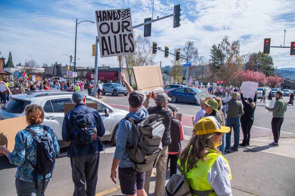 Sequim Gazette photo by Emily Matthiessen/ According to a clicker count by volunteers with Sequim Indivisible, 1298 people turned out by 11:45 a.m., with nearly 1400 people counted by 2:00 p.m. during Sequim's version of the "Hands Off " protests held across the nation and in other countries on Saturday. The protest was peaceful and orderly, according to police, organizers and protesters and featured a range of protest signs.