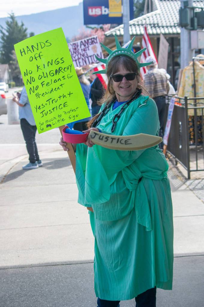Sequim Gazette photo by Emily Matthiessen/ According to a clicker count by volunteers with Sequim Indivisible, 1298 people turned out by 11:45 a.m., with nearly 1400 people counted by 2:00 p.m. during Sequim's version of the "Hands Off " protests held across the nation and in other countries on Saturday. The protest was peaceful and orderly, according to police, organizers and protesters and featured a range of protest signs.