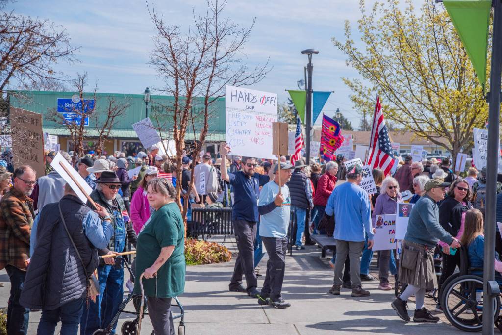 Sequim Gazette photo by Emily Matthiessen/ According to a clicker count by volunteers with Sequim Indivisible, 1298 people turned out by 11:45 a.m., with nearly 1400 people counted by 2:00 p.m. during Sequims version of the Hands Off  protests held across the nation and in other countries on Saturday. The protest was peaceful and orderly, according to police, organizers and protesters and featured a range of protest signs.