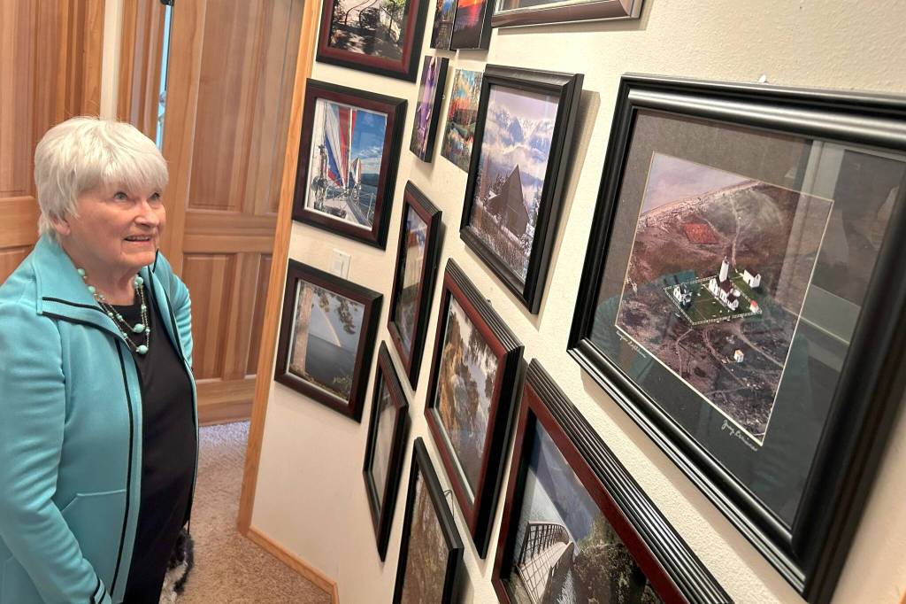 Sequim Gazette photo by Matthew Nash/ One hallway in Judy Larimores home is filled with countless photographs from her many trips. Everyday is a new adventure, she said.