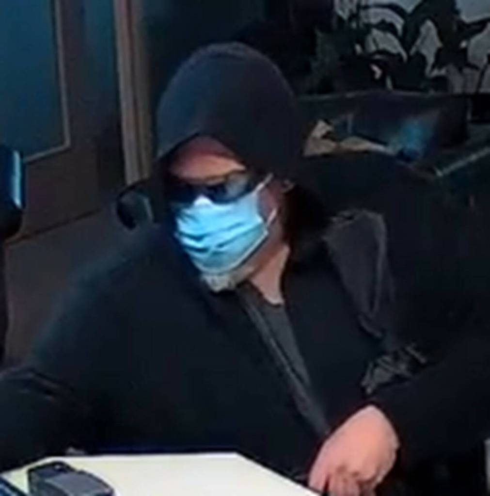 Photo courtesy Sequim Police Department/ On April 10, Sequim Police Department released screenshots of video surveillance of a man who is alleged to have robbed Kitsap Bank in Sequim on April 9. Police describe the Caucasian male as standing about 6 tall with a gray beard and heavy build.