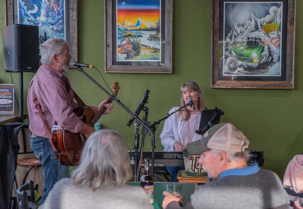 Sequim Gazette photo by Emily Matthiessen/ Steve Anderson on guitar and Dawn Martin on piano, sing and play for a crowded Rainshadow Cafe last First Friday Art Walk in Sequim.