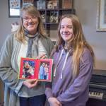 Sequim Gazette photo by Emily Matthiessen/ Piano teacher Dawn Martin holds photos of herself and one of her first students in Sequim, Avonlea Lawrence.