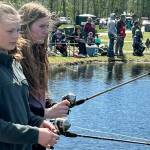 Sequim Gazette file photo by Matthew Nash/ Grace Dormer, and Zoei McCullem, both from Sequim, cast lines out for fish on Kids Fishing Day in 2024. This years event is set for April 19 in Carrie Blake Community Park.