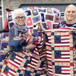 Sunbonnet Sue Quilt club Member Bonnie Cauffman, right, presents patriotic quilts made by members of the Sequim club to Betsy Reed Schultz, founder and executive director of Captain Joseph House Foundation in Port Angeles. The larger quilts will be used in Captain Joseph House, while the smaller comfort quilts will be presented to Gold Star family members. The Captain Joseph House Foundation is a one-of-a-kind 501(c)3 nonprofit that supports Gold Star Families of the U.S. militarys fallen war heroes since 9/11 from all branches of the military.<ins> The foundation looks to ensure a place for families of the fallen to gather for respite and to provide a continuum of care for their personal healing. For more about the Captain Joseph House Foundation, see <a href="https://captainjosephhousefoundation.org" target="_blank">captainjosephhousefoundation.org</a>. </ins>