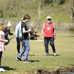 Sequim Gazette photo by Matthew Nash/ Ninth grader Justice Loftus catches a fish on April 18 as part of a preview for Kids Fishing Day.