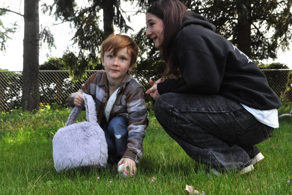 Sequim Gazette photo by Matthew Nash/ Artem Cummings, 5, searches for eggs with his sister Alivia Cummings, 12, during the Sequim Elks annual Easter egg hunt. The siblings said they come to the event every year.