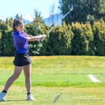 Sequims Raimey Brewer completes her swing and eyes her drive during the Wolves Olympic League girls golf match with Olympic at The Cedars at Dungeness on April 17.