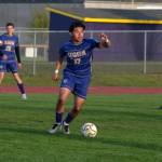 Sequim Gazette photo by Emily Mathiessen/ Evan Cisneros moves the ball up the field against Bremerton on April 18. The Wolves won 3-1.