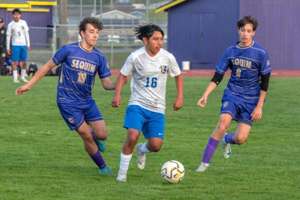 Sequim Gazette photos by Emily Mathiessen
Sequims Nico Musso (19) and Sebastian Buhrer (6) surround Bremertons Luis Funez Ramos (16) in the Wolves 3-1 victory over Bremerton in Sequim on Friday.