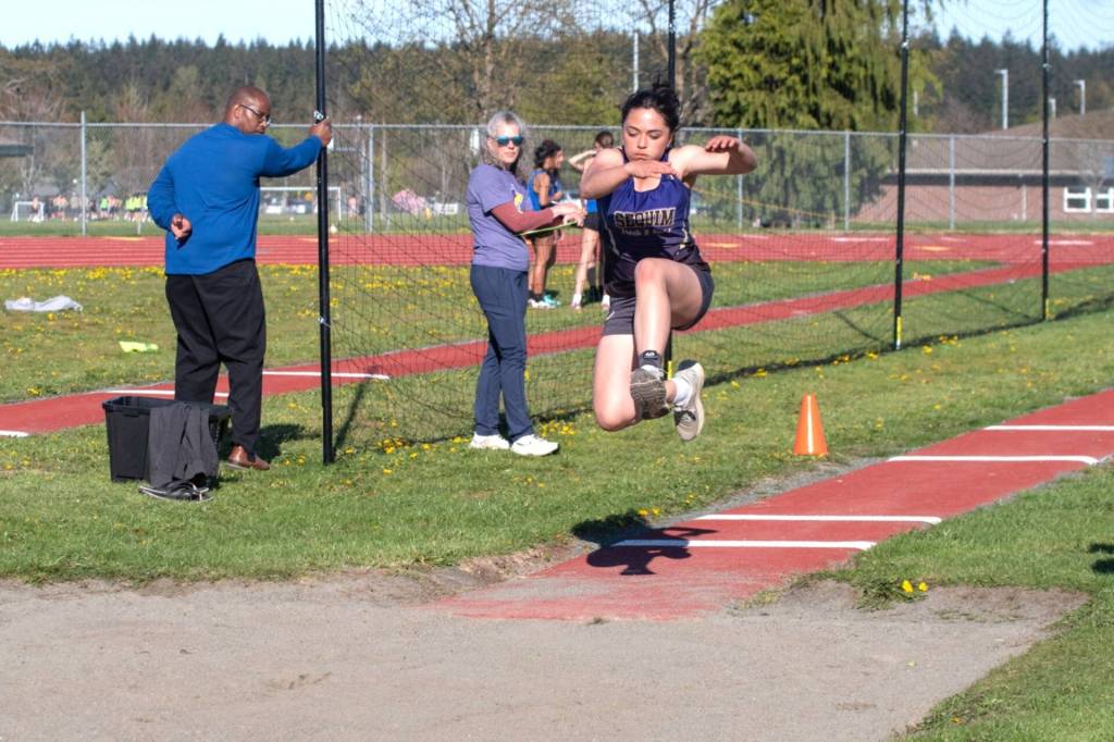 Sequim Gazette photo by Emily Mathiessen/ Ahrya Klinger jumps during a home meet in Sequim on April 17.