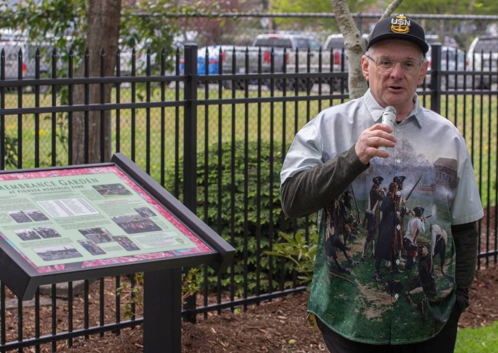 Sequim Gazette photo by Emily Matthiessen/ National Historical Preservationist Mick Hersey speaks on April 19 at the dedication of Pioneer Memorial Parks Memorial Garden. Beside him a newly made informational sign details the history of the Garden.