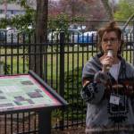 Sequim Gazette photo by Emily Matthiessen/ Susan Mannisto with the Sequim Prairie Garden Club speaks on April 19 at the dedication of Pioneer Memorial Parks Memorial Garden. Beside her a newly made informational sign details the history of the Garden.