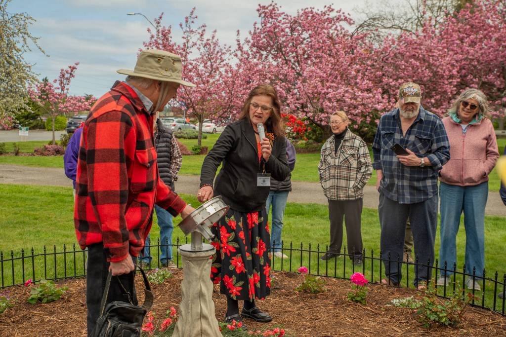 Sequim Gazette photo by Emily Matthiessen/ Susan Mannisto with the Sequim Prairie Garden Club speaks on April 19 at the dedication of Pioneer Memorial Parks Memorial Garden.