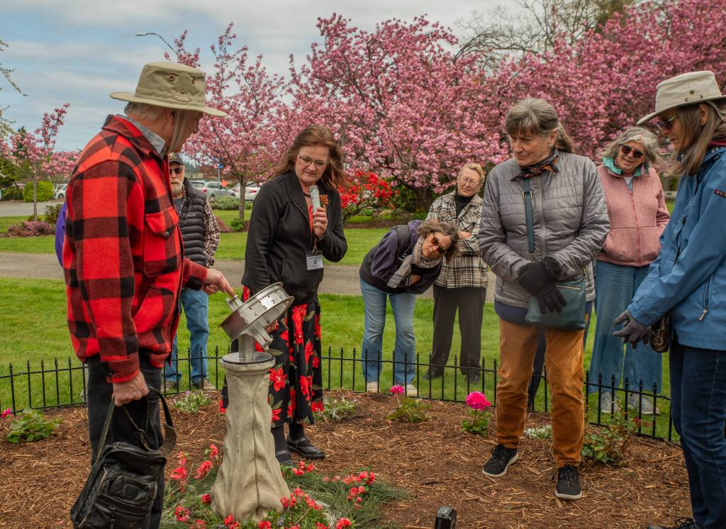 Sequim Gazette photo by Emily Matthiessen/ Joe LaCour explains to an audience of pioneer descendants, Sequim Prairie Garden Club members and others how he made the sundial for new Sundial Garden at the Pioneer Memorial Park, which was dedicated during a ceremony on Saturday, April 19. The garden club also dedicated the refurbished Remembrance Garden.
