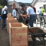 Kevin Harkins, a board member of Sarges Veterans Support, and volunteers from Sequim Community Church fill wheelchair-accessible planter boxes for LtCol James Minsky Place, a home for elderly and/or disabled veterans. Theyre accomplishing the impossible, Harkins said of efforts from businesses and volunteers. Large rocks were removed and a landscaping plan, bark, trees, flowers and bushes were all donated for the project, he said.