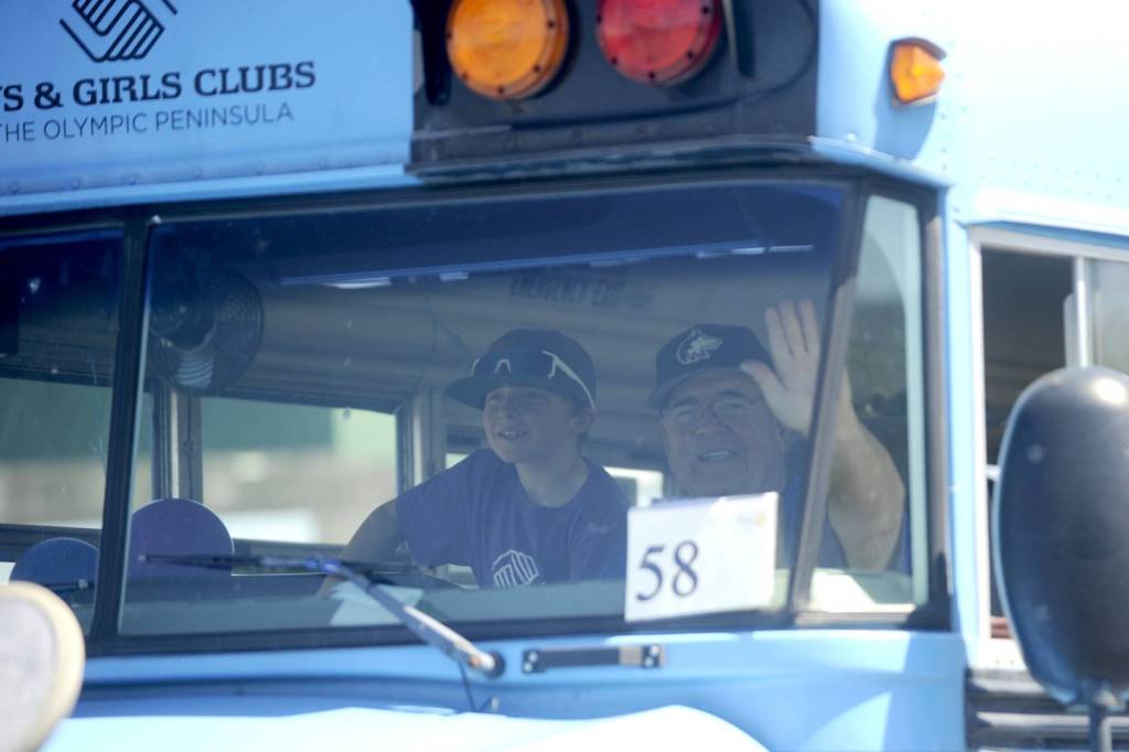 Sequim Gazette photo by Michael Dashiell/ Volunteer Stephen Rosales drives the Boys & Girls Clubs bus during the Sequim Irrigation Festivals Grand Parade in 2024. The club has been a fixture of the Grand Parade for many years.