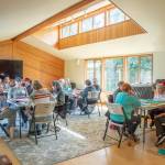 A group of locals play American Mahjong at the Harmony Center of Sequim in the activities room, which is large and well-lit, with Wi-Fi, a 70 television, folding tables and chairs.