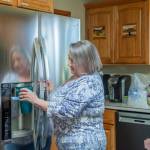 Sequim Gazette photo by Emily Matthiessen/ Manage Cassandra Cockrill fills a glass of water for a visitor in the communal kitchen at the Harmony Center of Sequim.