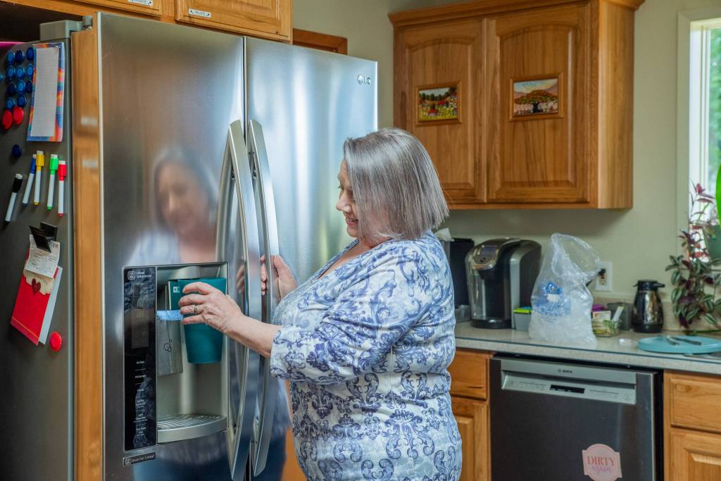 Sequim Gazette photo by Emily Matthiessen/ Manage Cassandra Cockrill fills a glass of water for a visitor in the communal kitchen at the Harmony Center of Sequim.