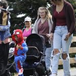 Sequim Gazette photo by Matthew Nash/ Jennifer Castillo walks along with her 3-year-old son Adriel in a Spider-Man costume during the Kids Parade. Castillo, a 2013 Sequim High grad, said her family just moved back to the area and they wanted to participate in Sequim events.