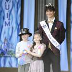Sequim Gazette photo by Matthew Nash/ Braylen Williams and Adeline Gleason win the ribbon at the Kids Parade for the best festival theme costumes from festival prince Malachi Byrne.