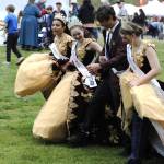 Sequim Gazette photo by Matthew Nash/ Sequim Irrigation Festival royalty, from left, Joanna Morales, Roxy Woods, Malachi Byrne, and queen Lily Tjemsland make it through the three-legged race as a five-legged team.